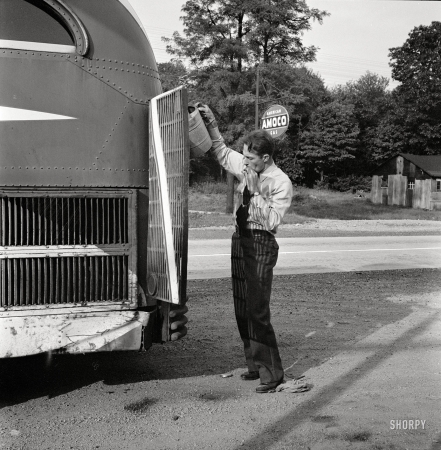 Photo showing: Watering the Dog -- September 1943. A Greyhound bus that has been stopped at
a filling station to get water between Washington, D.C., and Pittsburgh.