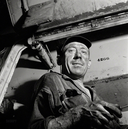Photo showing: Hound Doc -- September 1943. Pittsburgh, Pennsylvania. A mechanic at the Greyhound garage.