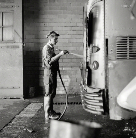 Photo showing: Dog Wash -- September 1943. Pittsburgh, Pa. Bus serviceman washing
a coach which has just come in from a run in the Greyhound garage.