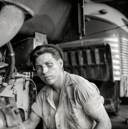 Photo showing: The Bus Whisperer -- September 1943. Pittsburgh, Pennsylvania. Mechanic in the Greyhound bus garage.