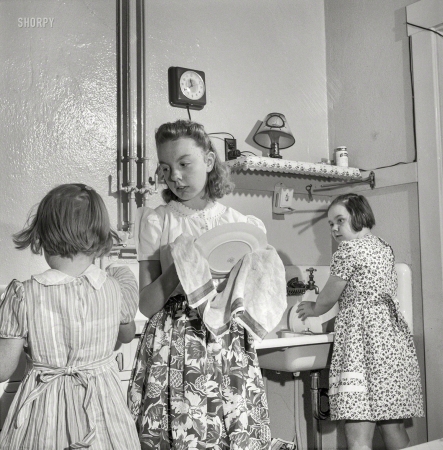Photo showing: Wash and Dry -- September 1943. Cincinnati, Ohio. Children of Bernard Cochran, a Greyhound bus driver, doing dishes after Sunday dinner.