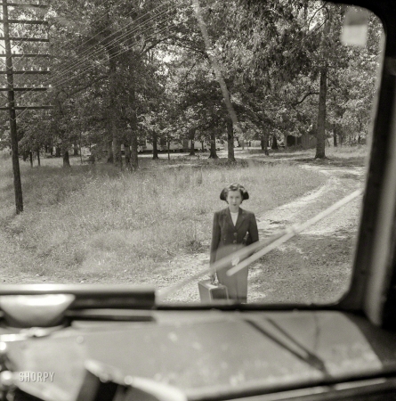 Photo showing: Another Passenger -- September 1943. Greyhound bus trip from Louisville to Memphis and the terminals. Girl waiting for bus by road's edge.