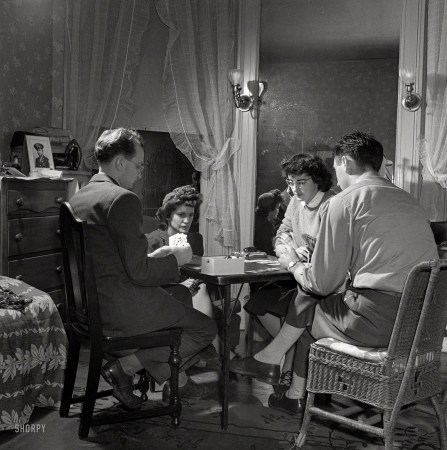 Photo showing: Four No Trump -- January 1943. Washington, D.C. After dinner a bridge game goes on nightly in the largest room in the boardinghouse.