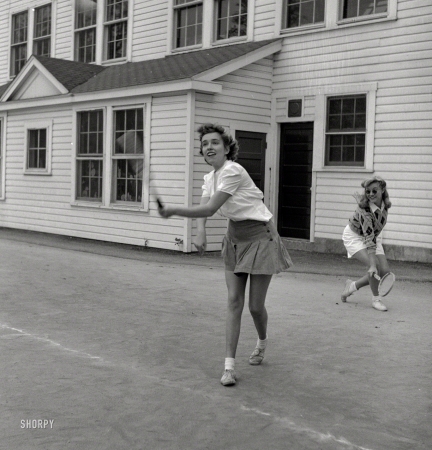 Photo showing: Volley of the Dolls -- October 1943. Washington, D.C. Sally Dessez, a student at Woodrow Wilson High School, playing a tennis match.