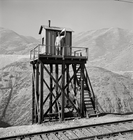 Photo showing: At the Signal -- November 1942. Bingham Canyon, Utah. Signalman
of the Utah Copper Company at its open-pit mine workings.