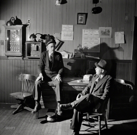 Photo showing: Fire Chief -- May 1942. Southington, Conn. Fire Chief Thomas J. Murphy chatting with one of the volunteers. 