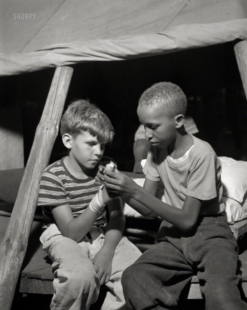 Photo showing: Splint in a Tent -- August 1943. Southfields, New York. Interracial activities at camp Nathan Hale. First aid.