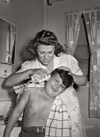 Photo showing: Can You Hear Me Now?? -- June 1942. Brooklyn, New York.  Mrs. Caputo washes her son Jimmy's ears.