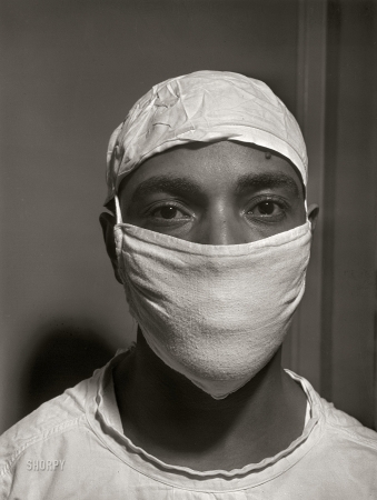 Photo showing: The Doctor Will See You Now -- March 1942. Provident Hospital, Chicago. Dr. S.J. Jackson, intern, ready to assist in an operation.