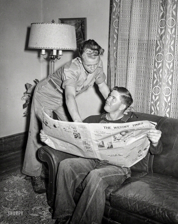 Photo showing: Current Events -- August 1942. Vernon County, Wisconsin. The E.J. Saugstad family at Arrowdale,
their 160-acre farm near Westby. Robert, aged sixteen, with hired man Alton Lee.