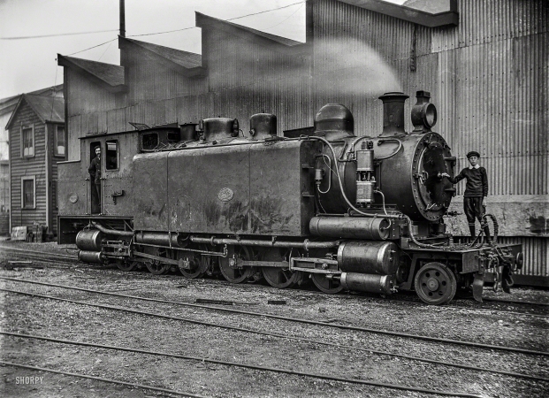 Photo showing: Iron Pony -- New Zealand circa 1905. E class locomotive, E 66, at the Petone
Railway Workshops, William Godber standing on the front.