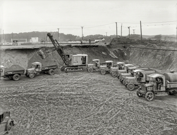Photo showing: Trucks Entering Highway -- The San Francisco Bay Area circa 1931. Earth-moving equipment and trucks.