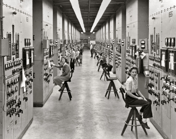 Photo showing: Calutron Girls -- Clinton Engineer Works, Oak Ridge, Tennessee, 1944. Calutron Girls -- Gladys Owens
(foreground), one of the workers monitoring 'Calutron' mass spectrometers
at the Y-12 uranium isotope separation and enrichment plant.