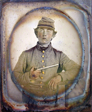 Photo showing: Born a Rebel -- Ca. 1861-65. Young soldier in Confederate shell jacket and forage cap with single shot pistol.