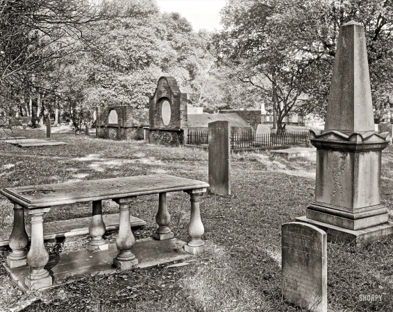 Photo showing: Table for One -- 1939. Savannah, Georgia. Stone monuments and brick vaults in Colonial Park, formerly South Broad Street Cemetery.