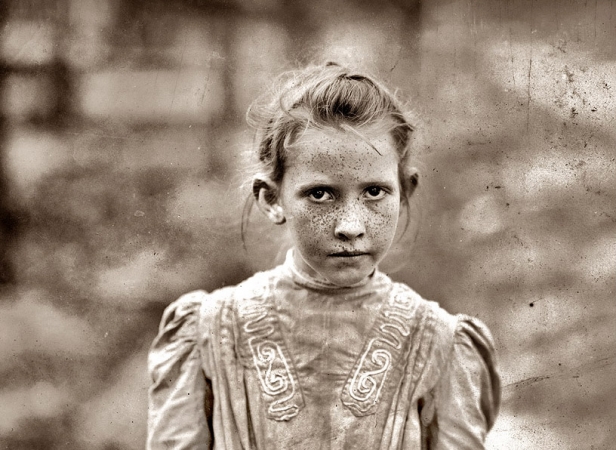 Photo showing: The Stare -- 1911, possibly Mississippi. Girl works all day in a cannery.