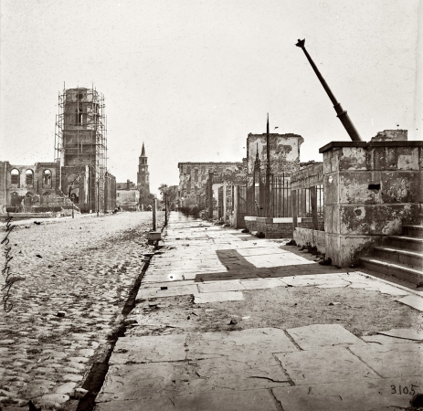 Photo showing: After the Bombardment: 1865 -- 1865. Charleston after the bombardment. Meeting Street, looking south, showing
St. Michael's Church, the Mills house and ruins of the Circular Church.