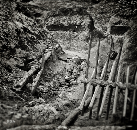 Photo showing: The Siege of Petersburg -- April 3, 1865. Petersburg, Virginia. Dead Confederate soldiers in trench beyond a section of chevaux-de-frise.