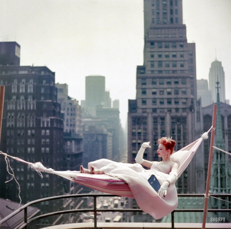 Photo showing: Cool Pink -- May 1953. Dancer-actress Gwen Verdon in a hammock wearing a ballgown.
