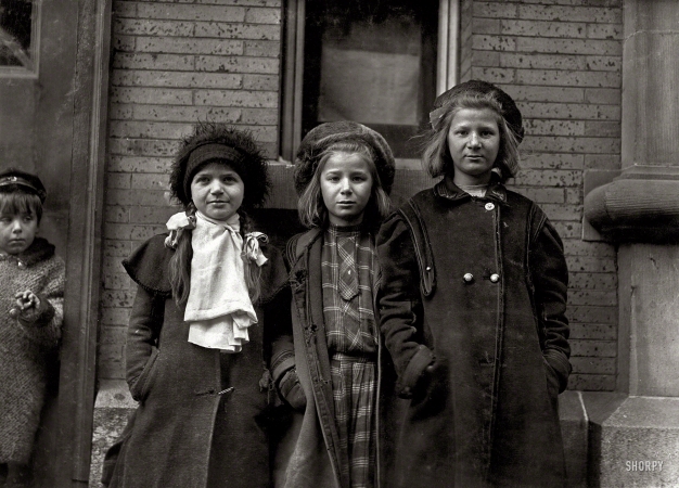 Photo showing: Salty Alice -- March 1909. Hartford, Connecticut. Newsgirls waiting for papers. Largest girl, Alice Goldman,
has been selling for 4 years. Newsdealer says she uses viler language than the newsboys do.