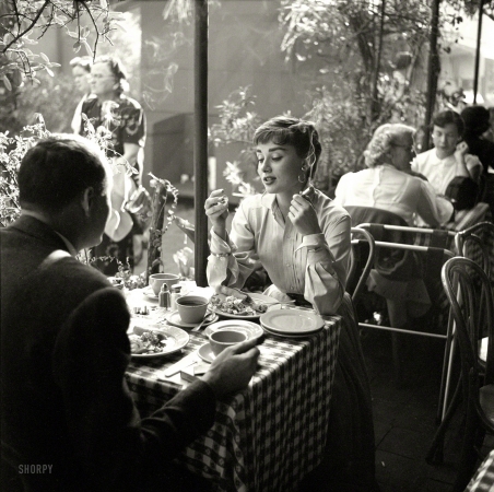 Photo showing: Mexican Holiday -- Circa 1953. Actress Audrey Hepburn with dining companion in Mexico.