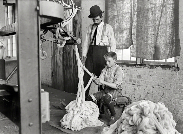 Photo showing: Warping Boy -- December 1908. Boy at warping machine, Catawba Cotton Mill. Newton, N.C.