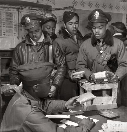Photo showing: Tuskegee Airmen: 1945 -- March 1945.  'Escape kits' (cyanide) being distributed to fighter pilots at air base in Ramitelli, Italy.  