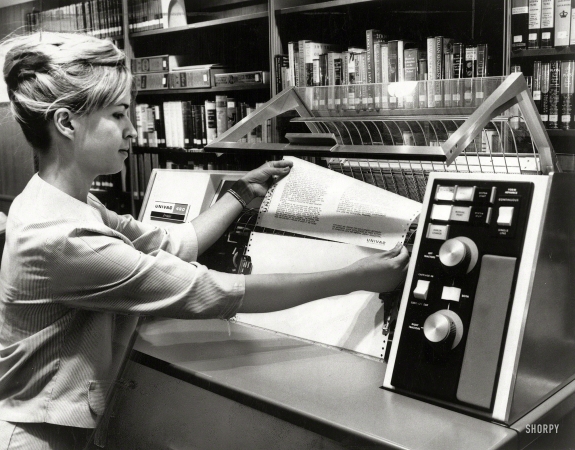 Photo showing: Cyber Monday -- 1966. To the rescue. Many librarians believe computers are the only means to effectively cope with their bulging bookshelves.