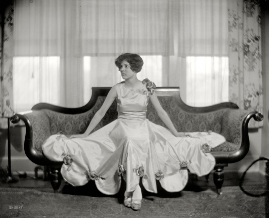 Photo showing: Ensconced -- Washington, D.C., circa 1925. A sofa-size portrait of Miss Katherine Kellond.