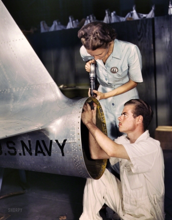 Photo showing: Texas Tail -- August 1942. Corpus Christ, Texas. Mrs. Virginia Davis, a riveter in the assembly and repair
department of the Naval Air Base, supervises Chas. Potter, a NYA trainee from Michigan.