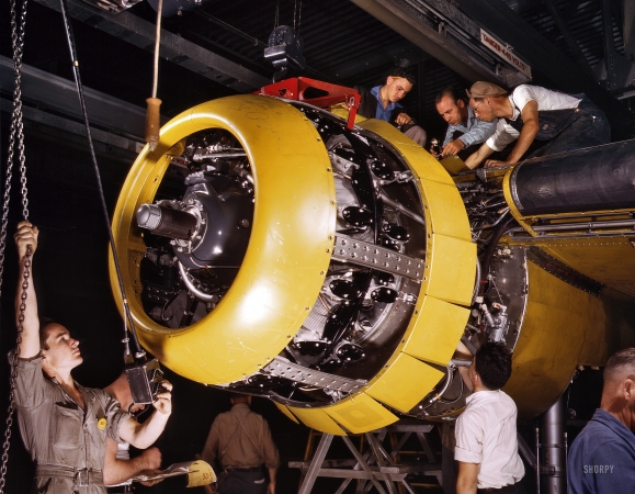 Photo showing: B-25 Whirlwind -- July 1942. Mounting 1700-horsepower Wright Whirlwind engine to a B-25 bomber. Fairfax bomber plant, Kansas City.