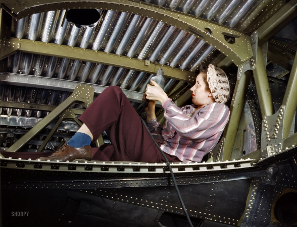 Photo showing: Rosie Rivets: 1942 -- An A-20 bomber being riveted by a woman worker with a power drill. Douglas Aircraft plant at Long Beach, California. 