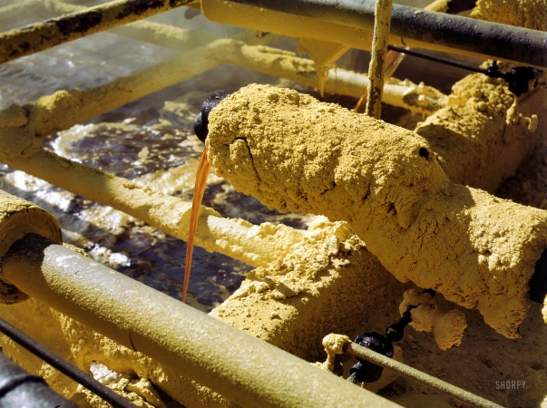 Photo showing: The Yellow Ooze of Texas -- May 1943. Melted sulfur from the wells pouring into relay station. Freeport Sulphur Co., Hoskins Mound, Texas.