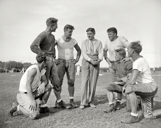 Photo showing: George and the Redskins -- Sept. 11, 1937. Washington, D.C. George Marshall, owner of the Washington Redskins, talks it over with some
of his players, left to right: Wayne Millner, tackle, end; Charlie Malone, end; Vic Carroll, tackle;
George Marshall and Bill Young, tackle; Ed Michaels, guard; Jim Garber, tackle. 