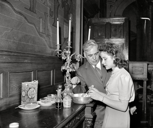 Photo showing: Cheese Ritz -- Nov. 24, 1939. Washington, D.C. Noted in the diplomatic set for his expertness in concocting
new salads, Mexican Ambassador Senor Dr. Don Francisco Castillo Najera is now teaching his daughter,
Ermita, this culinary art. The Ambassador is especially adept at mixing salad with Mexican ingredients.