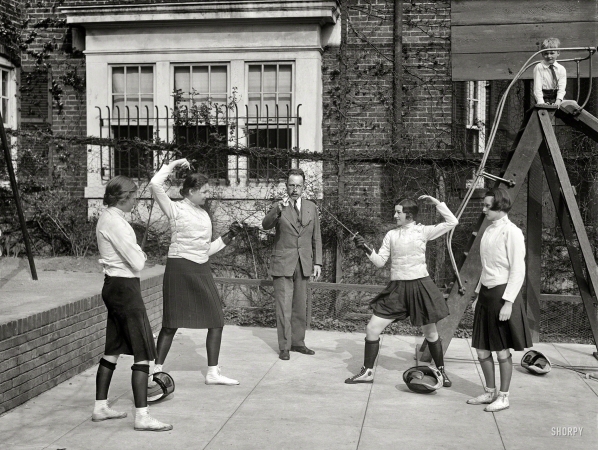 Photo showing: Ladies Who Lance -- April 16, 1930. Washington society girls will compete for fencing title of the District of Columbia at the Mayflower Hotel.
Elizabeth Bunting, judge; Priscilla Holcombe; Maj. Walter E. Blunt, referee; Margaret Montgomery; and Lillian Shuman, judge.