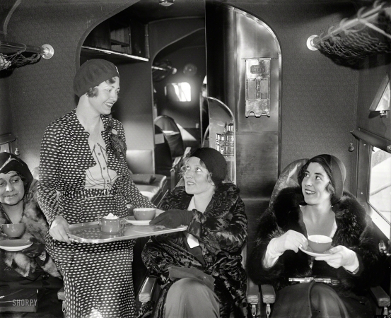 Photo showing: First Class -- January 10, 1930. Tea time in the air.