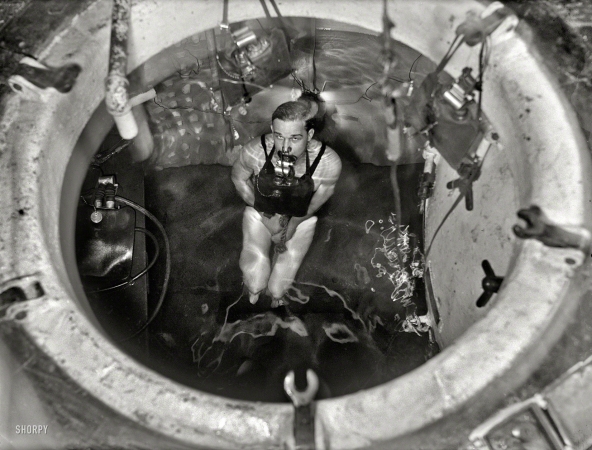 Photo showing: Dunk Tank -- Washington, D.C., 1931. Man partially submerged in tank with breathing appar­atus.