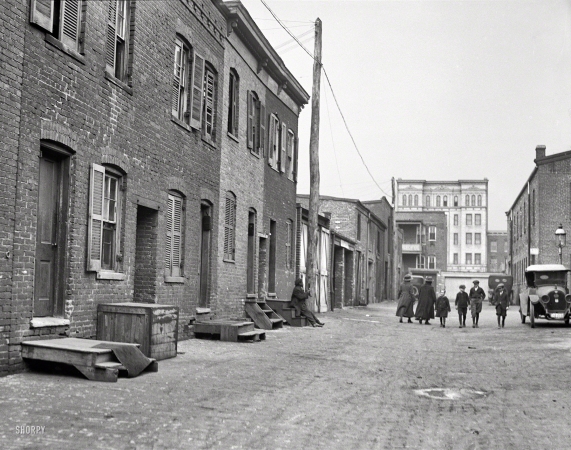Photo showing: The Poorer Quarters -- 1923. Washington, D.C. Blagden Alley looking north toward the Henrietta Apartments on N Street.