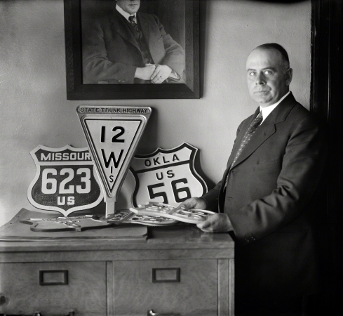 Photo showing: U.S. Highways -- Washington, D.C., 1925. Man with highway signs.