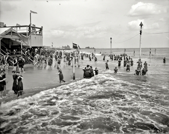 Photo showing: Coney Island Capers -- New York circa 1905. On the beach at Coney Island. Note the kites.