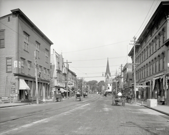 Photo showing: The Most Perfect Moving Pictures -- Circa 1907. Laconia, New Hampshire -- Main Street. Note handbill advertising the most perfect moving pictures.