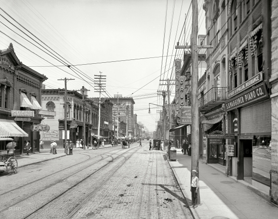 Photo showing: Mexican Mustang -- Knoxville, Tennessee, circa 1905. Gay Street looking north from Clinch Avenue.
Featuring the Mayor of Gay Street, and sponsored by Mexican Mustang Liniment.