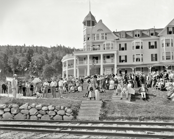 Photo showing: Taylor Tees Off -- September 1, 1900. Taylor about to drive from 1st tee across
the Ammonoosuc River. Mount Pleasant House, White Mountains, New Hampshire. 