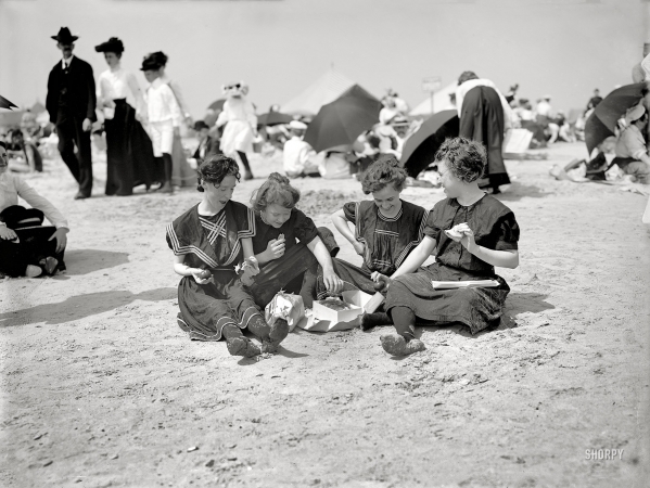 Photo showing: A Hasty Lunch -- Coney Island, New York, circa 1905. Picnicing on the beach -- a hasty lunch.
