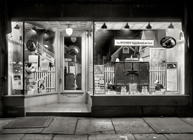 Photo showing: The Nippers of November -- New York, 1920. Store window display of the Graham Talking Machine Co. at 75 Graham Avenue in Brooklyn.