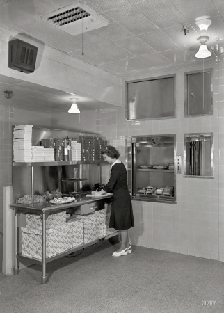 Photo showing: Pie Coming Up -- July 2, 1948. Schrafft's, Esso Building, Rockefeller Center. Dumbwaiter.