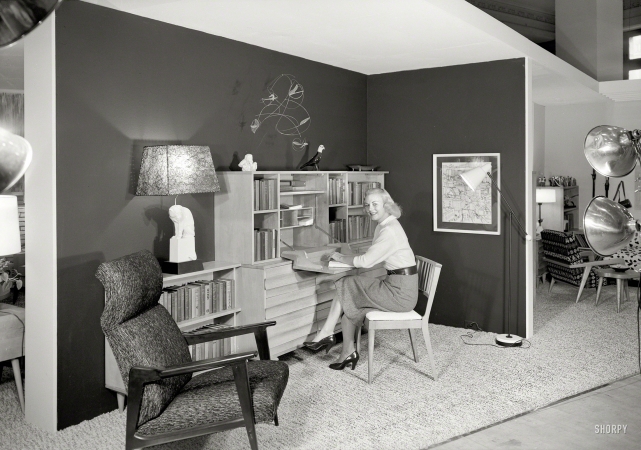 Photo showing: Blonde Bookworm -- Sept. 15, 1951. Ludwig Baumann, Grand Central Palace Exhibit. Library with model.