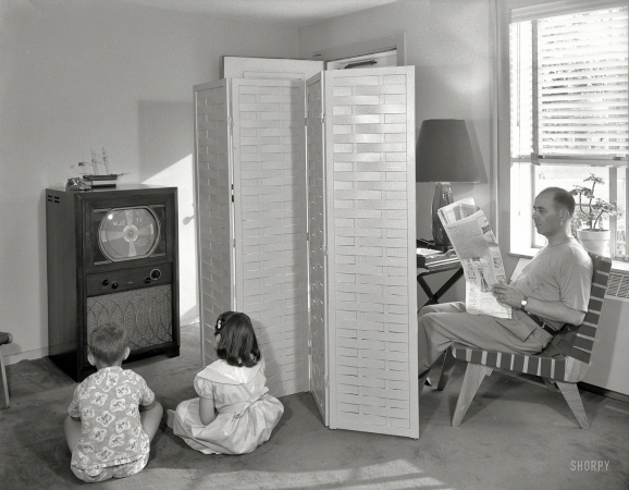 Photo showing: Television Screen -- July 12, 1950. Hilda Kassell, East 53rd Street, New York City. Father reading newspaper, children viewing television.