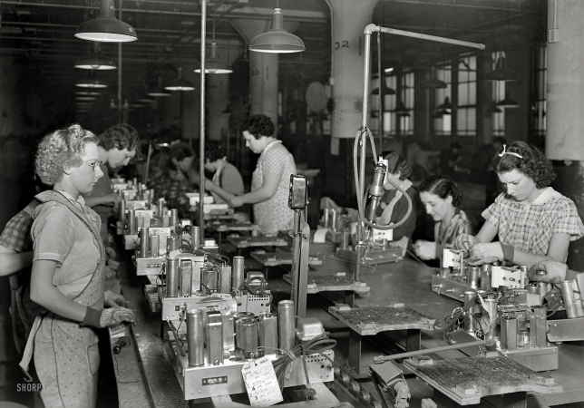 Photo showing: Five-Tube Chassis -- March 1937. Camden, New Jersey. RCA Victor. End of chassis assembly line for five-tube radio.